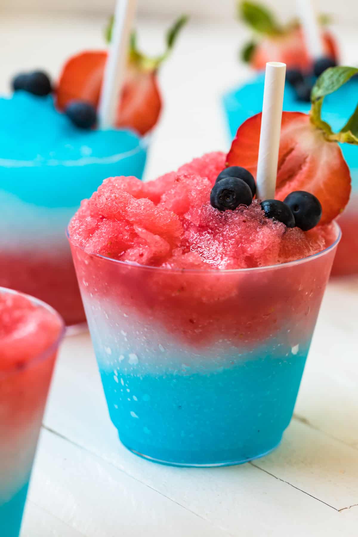 layered red, white, and blue margarita slushie with a straw
