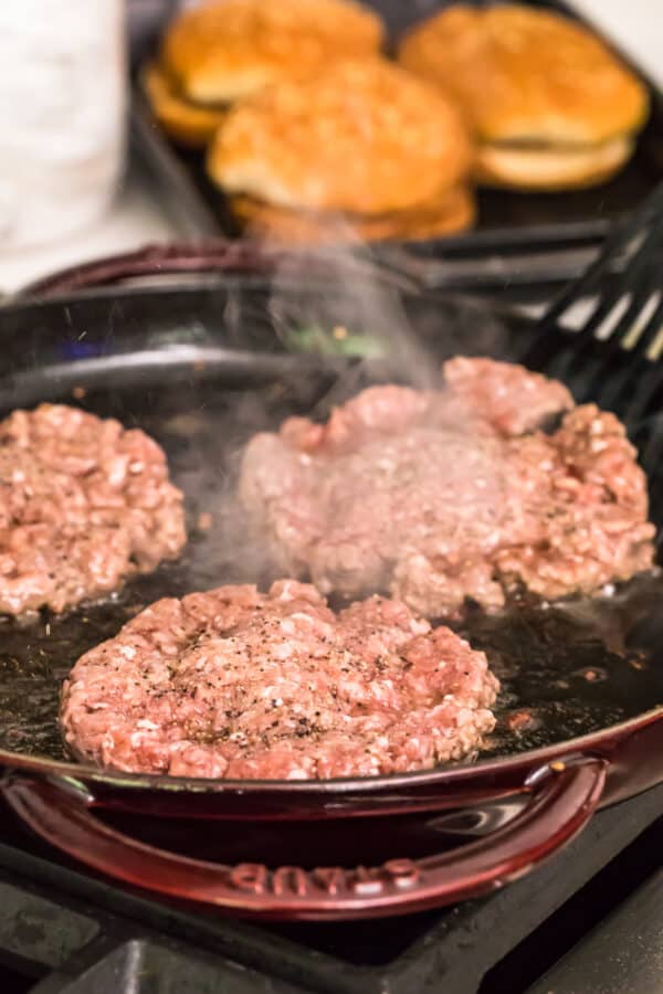 cooking burgers in a skillet
