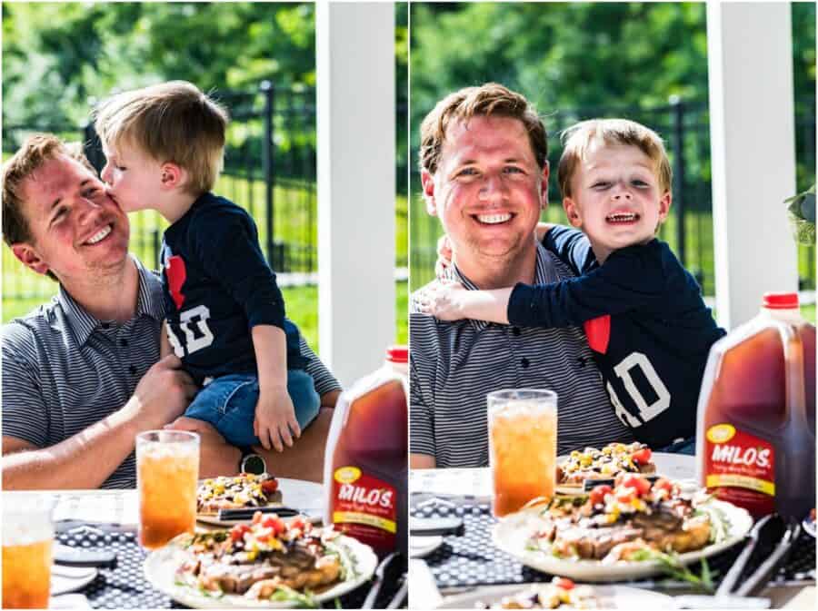 young son sitting with dad and smiling