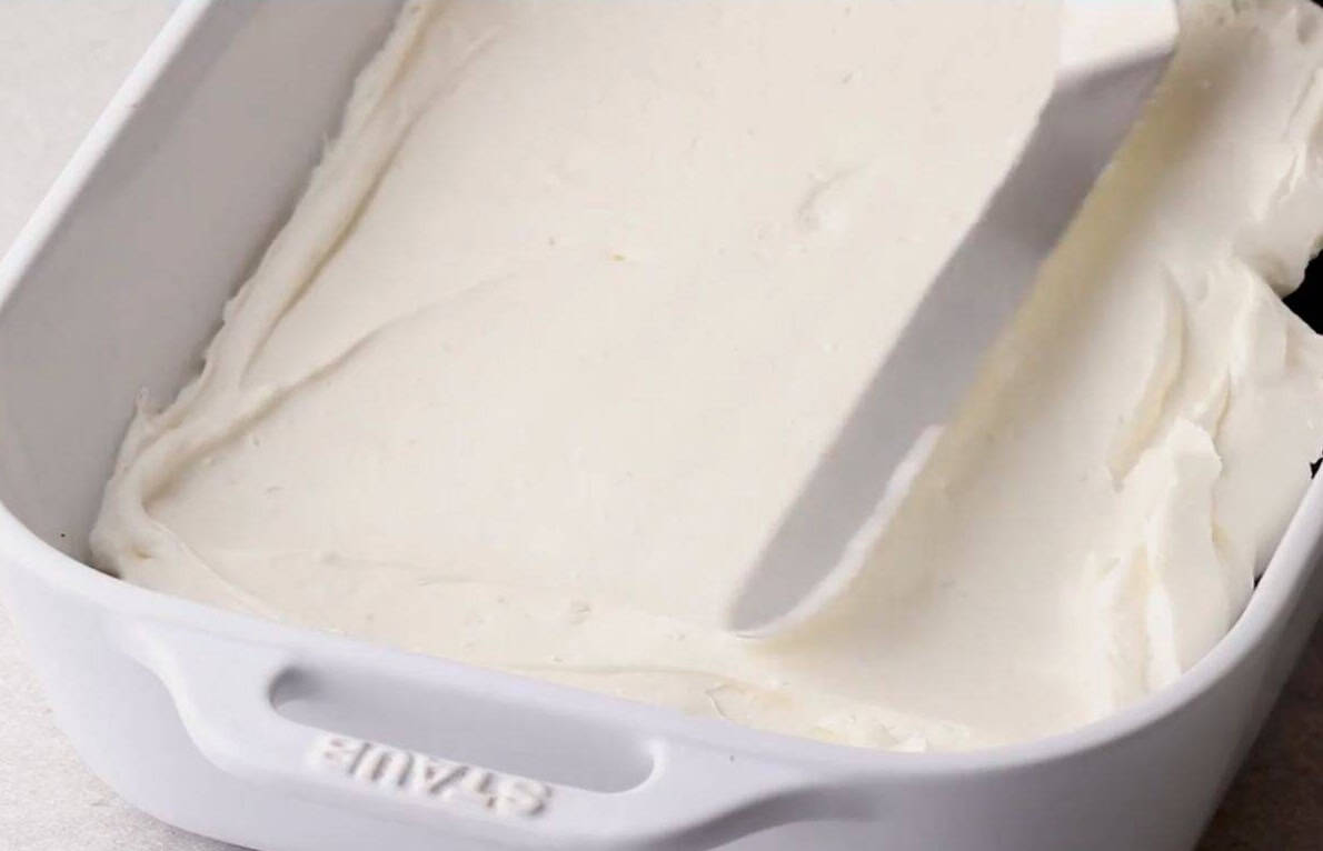 spread cream cheese layer over the oreo crust