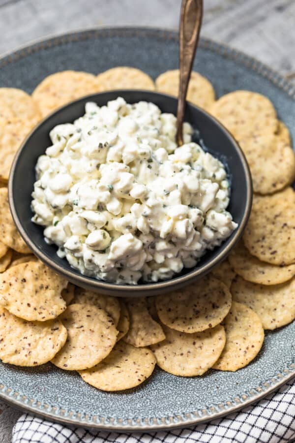 herbed cottage cheese in bowl surrounded by crackers