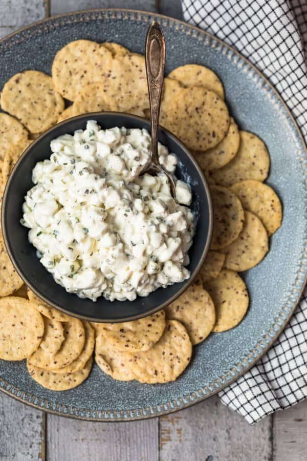 overhead image of herbed cottage cheese in bowl surrounded by crackers