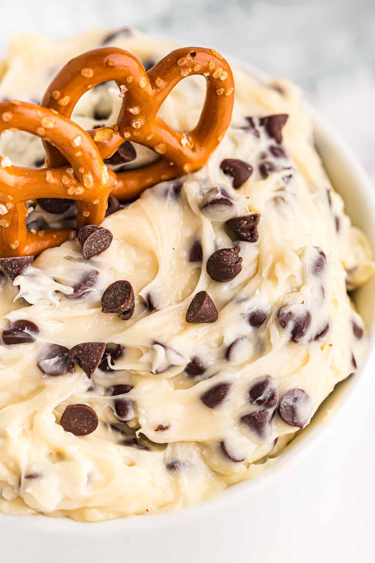 up close image of chocolate chip cookie dough dip with pretzels