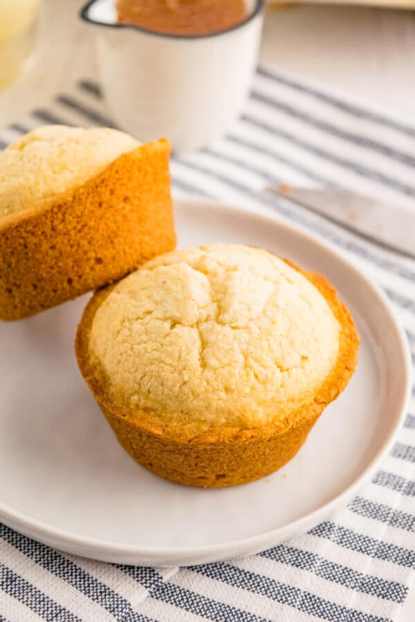 two cornbread muffins on white plate