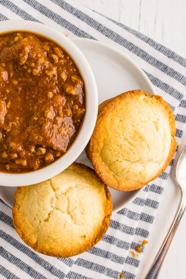 cornbread muffins next to bowl of chili