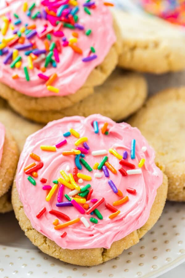 frosted sugar cookies with pink icing and sprinkles