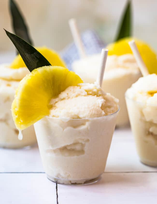 creamy frozen pina coladas in glasses garnished