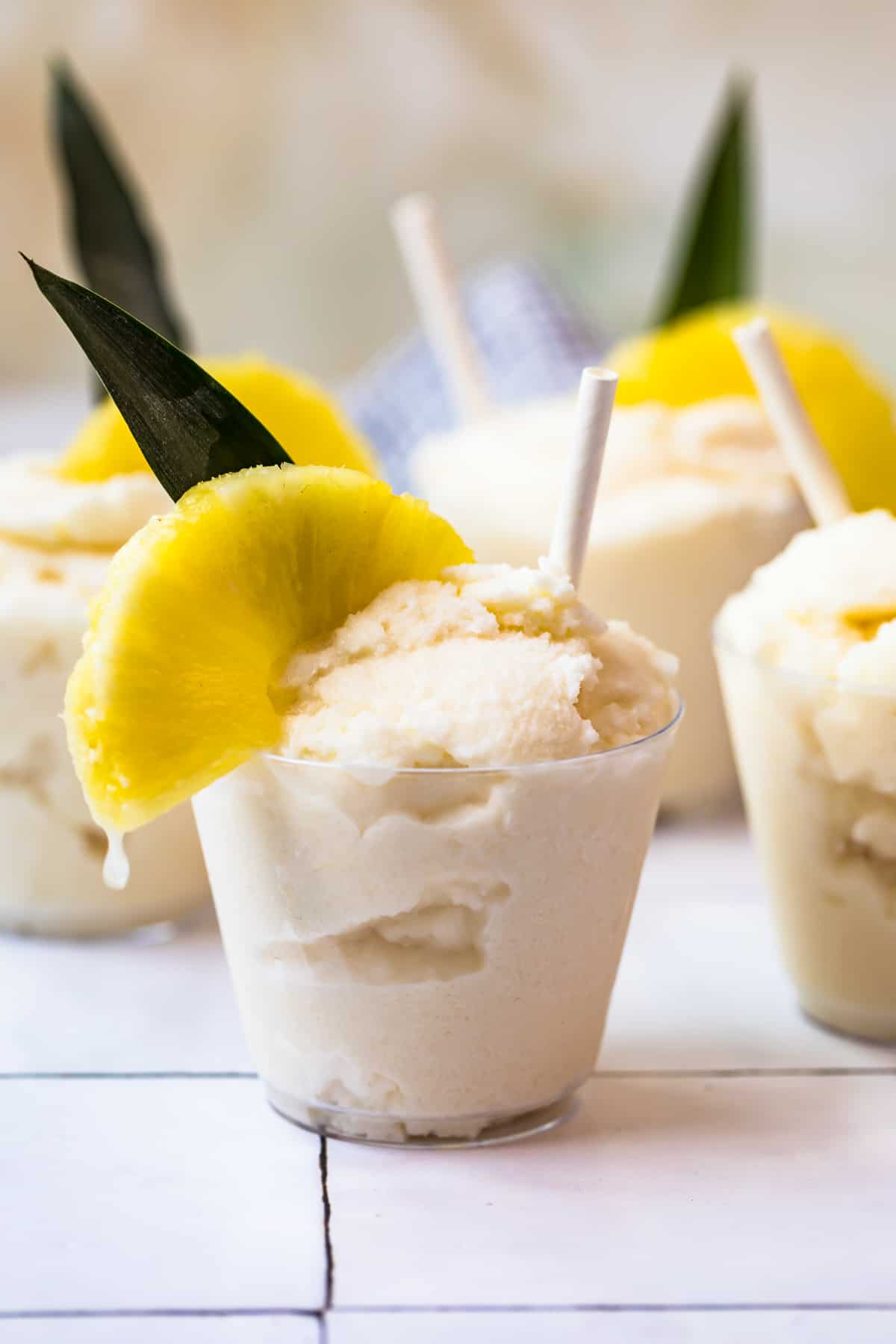 creamy frozen pina coladas in glasses garnished