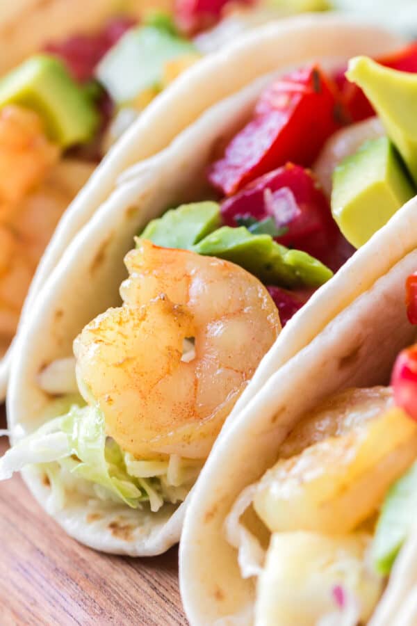 up close image of shrimp tacos with pineapple slaw