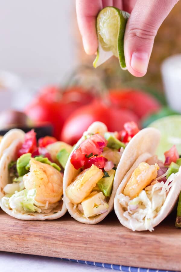 garnishing shrimp taco with lime juice