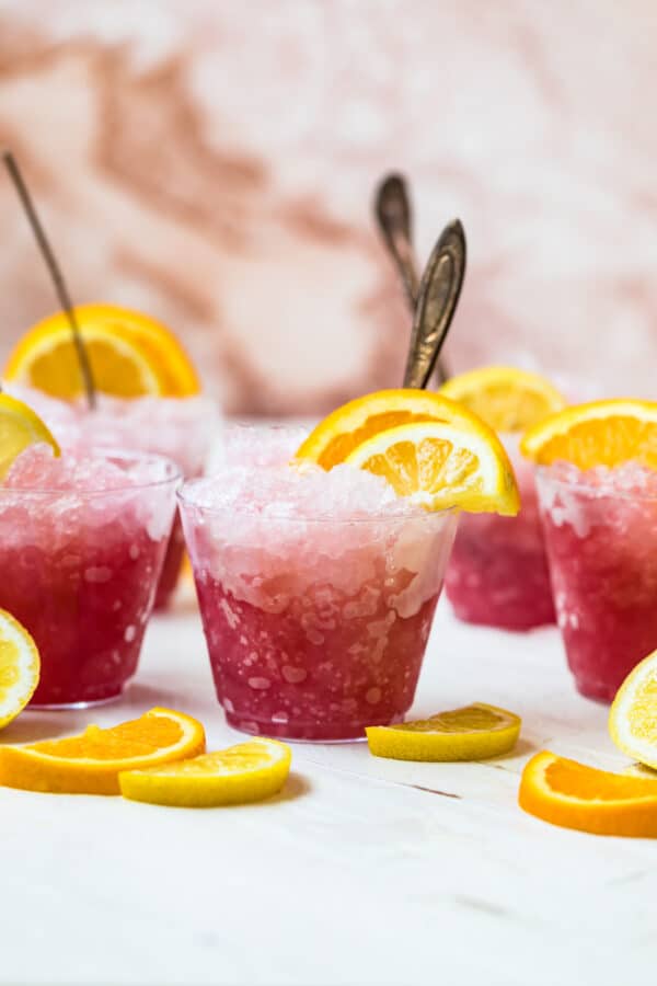 pink summer slushies in glasses with spoons