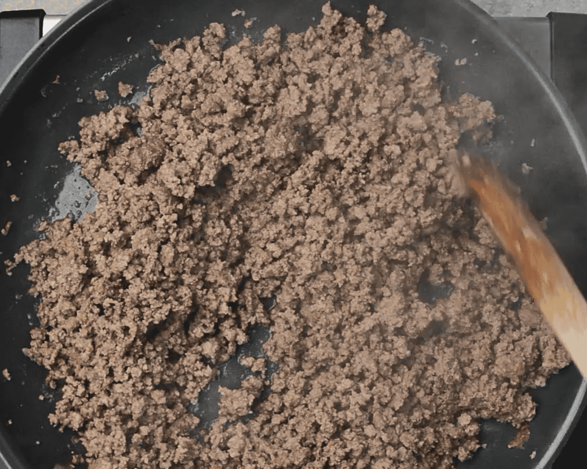 Cooked ground beef in a skillet.