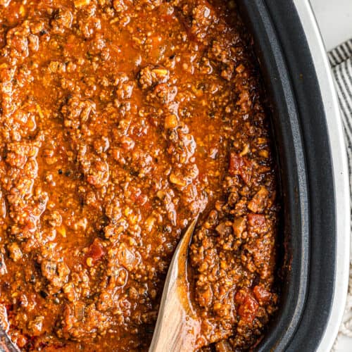 wooden spoon in spaghetti sauce in slow cooker