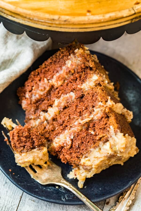 slice of german chocolate cake on black plate