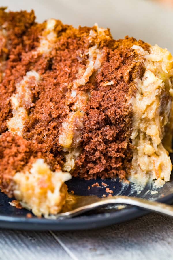 slice of german chocolate cake on black plate