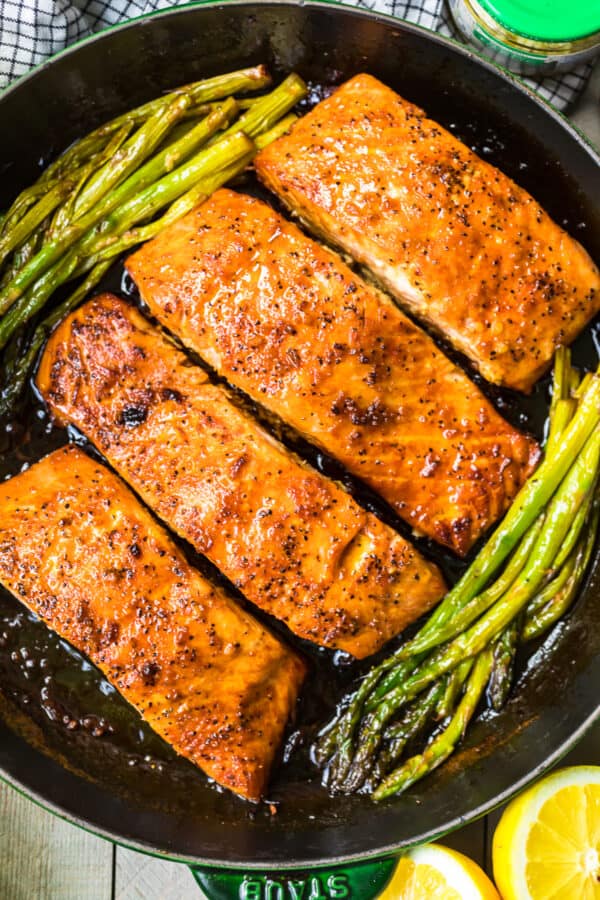 up close honey garlic salmon with asparagus in skillet