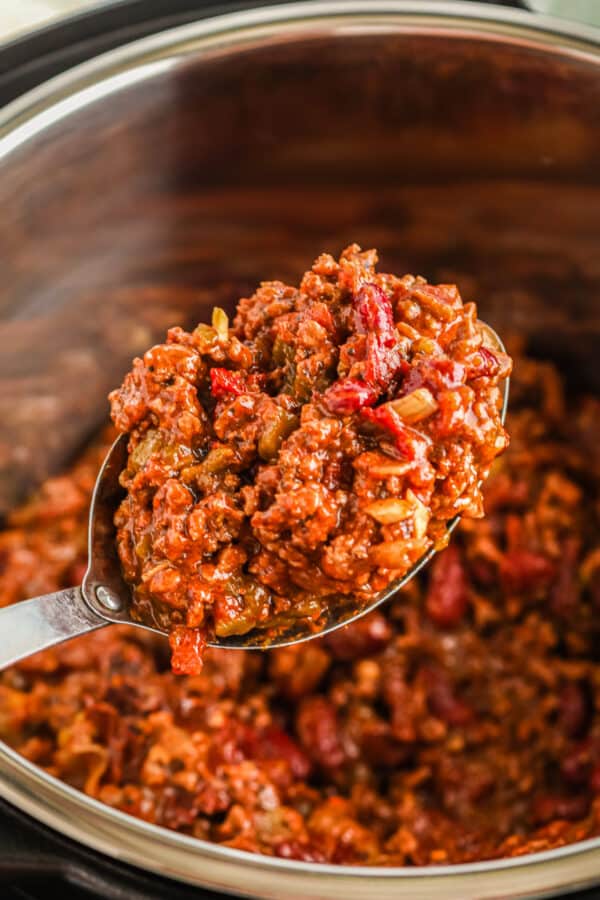 beef chili made in an instant pot being lifted by spoon