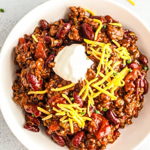 instant pot chili in bowl with cheese and sour cream