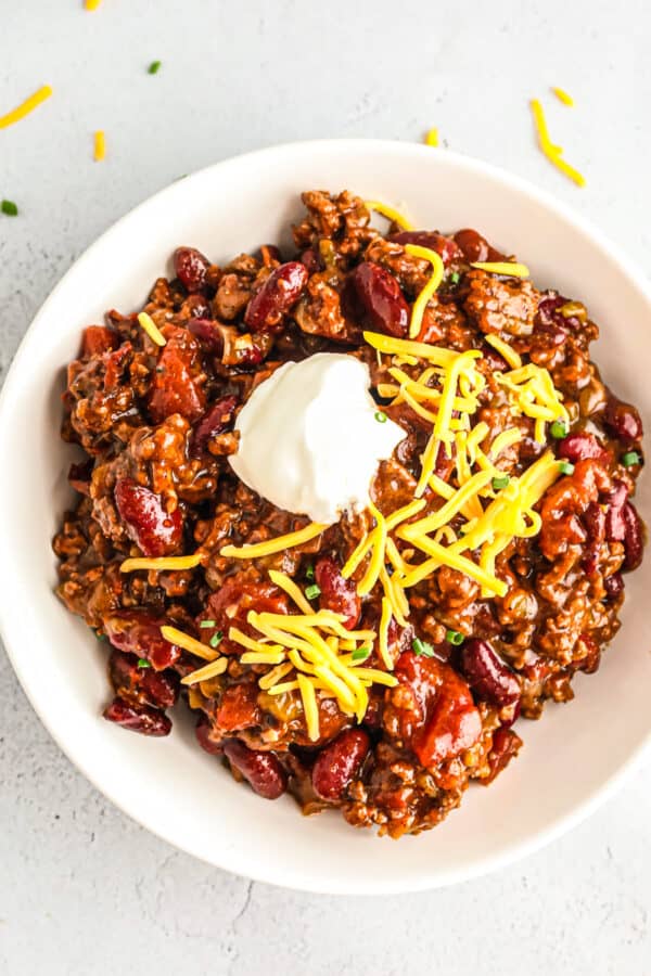 instant pot chili in bowl with cheese and sour cream