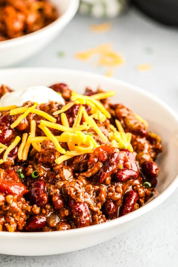 instant pot chili in bowl with cheese and sour cream