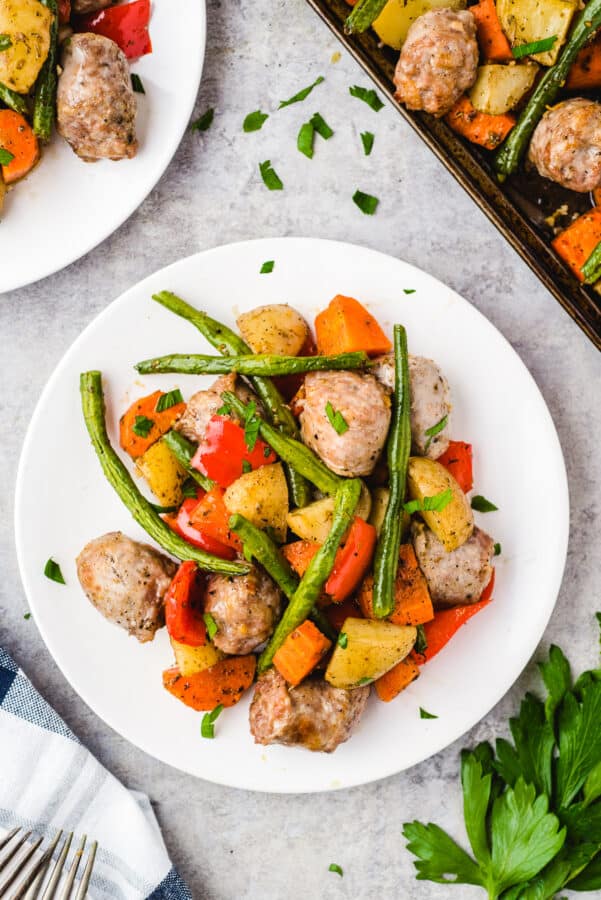 white plate with Italian sausage and vegetables