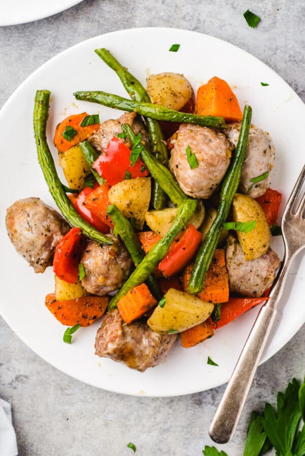 white plate topped with Italian sausage and veggies
