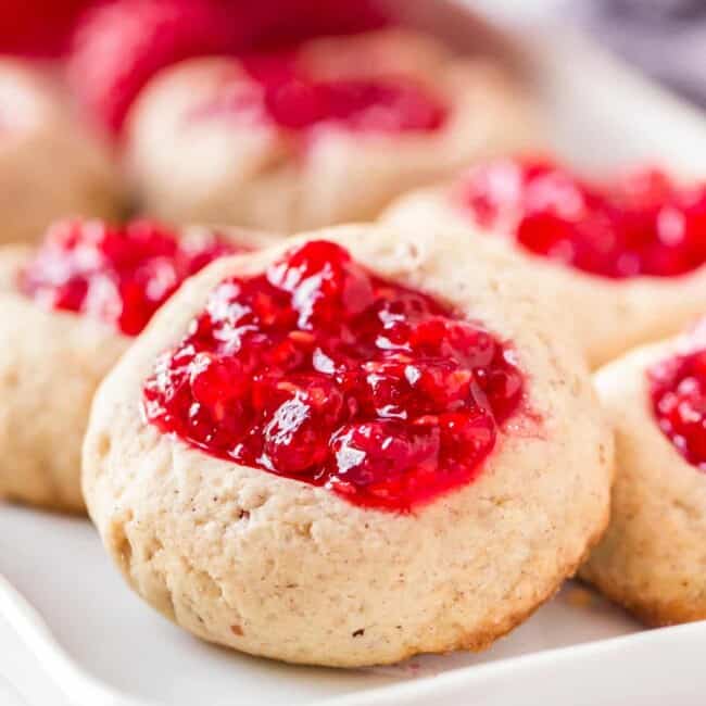 up close image of raspberry jam thumbprint cookies