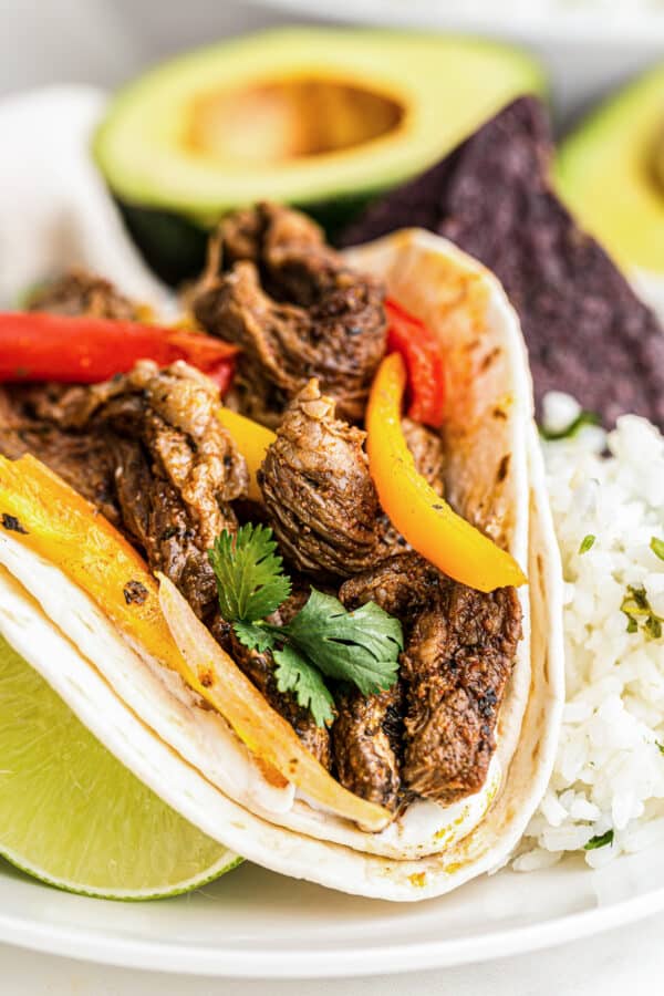 up close image of steak fajitas in tortilla