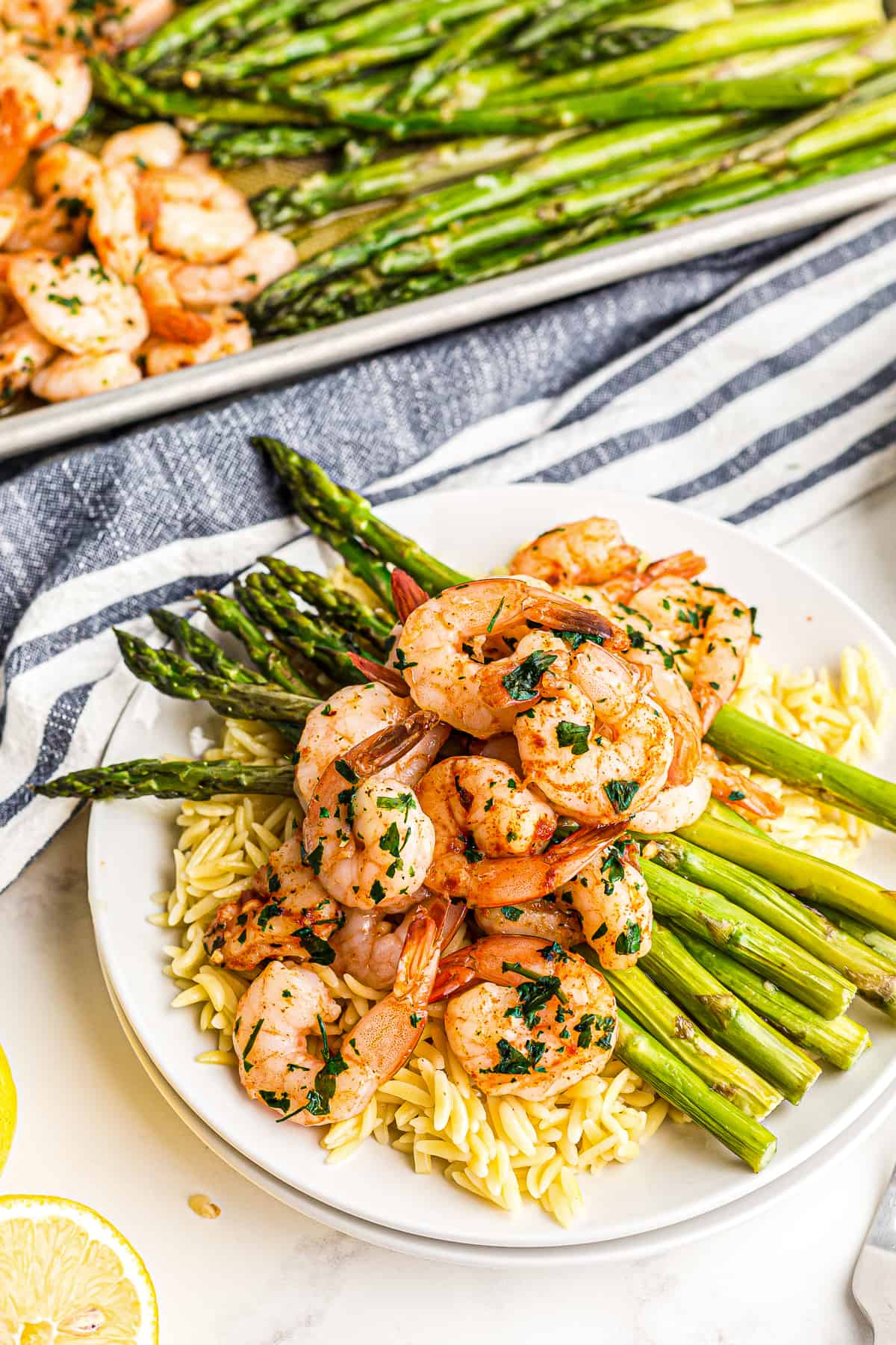 shrimp and asparagus over rice on plate