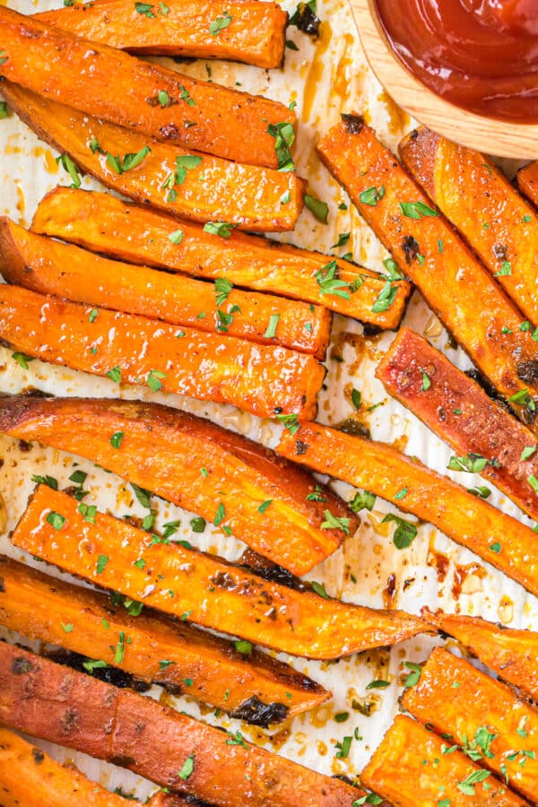 up close image of baked sweet potato fries on sheet pan