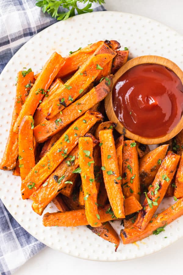 overhead image of sweet potato fries on plate with ketchup