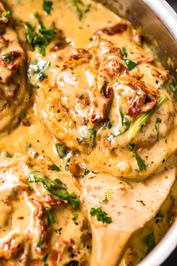 up close image of tuscan chicken in parmesan cream sauce