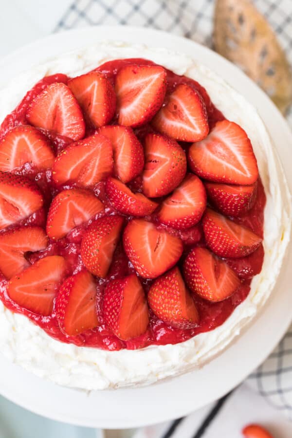 strawberries topping white layer cake