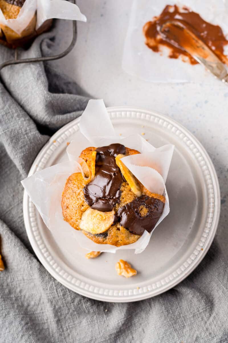 chocolate chunk banana muffin on white plate