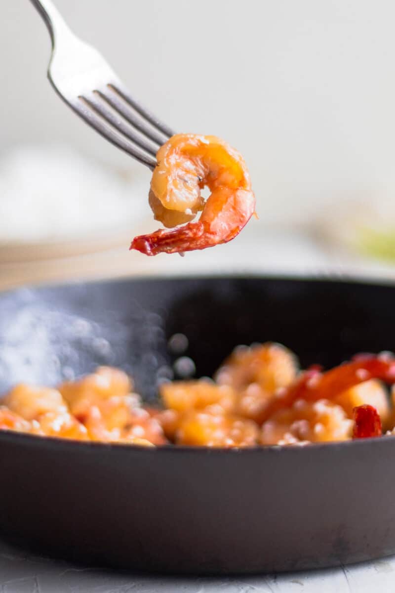 fork holding up cooked shrimp