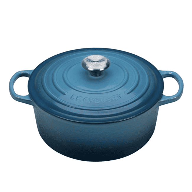 a blue cast iron dutch oven on a white background.