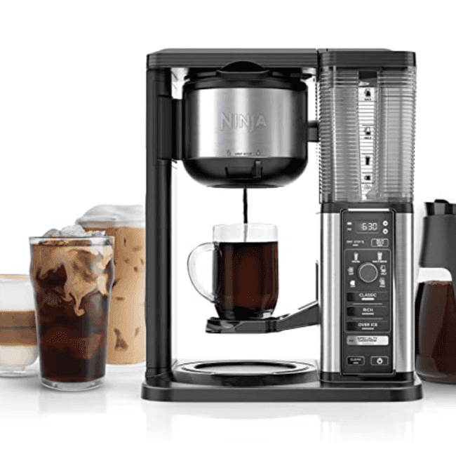 a coffee maker with a cup of coffee and a cup of iced coffee.