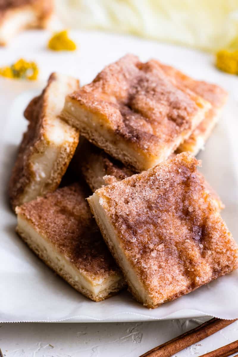 sopapilla cheesecake bars cut on platter