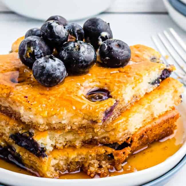 up close image of sheet pan blueberry pancakes with syrup