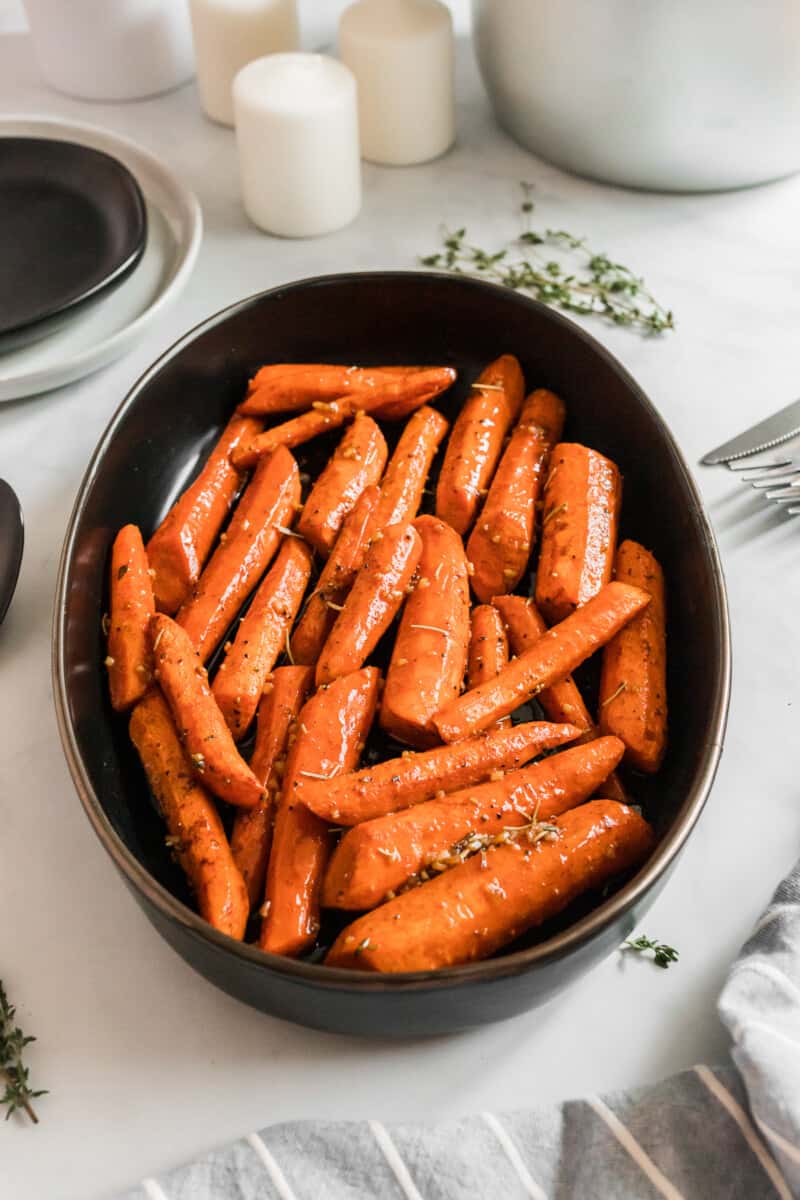 side shot of brown sugar carrots in serving dish