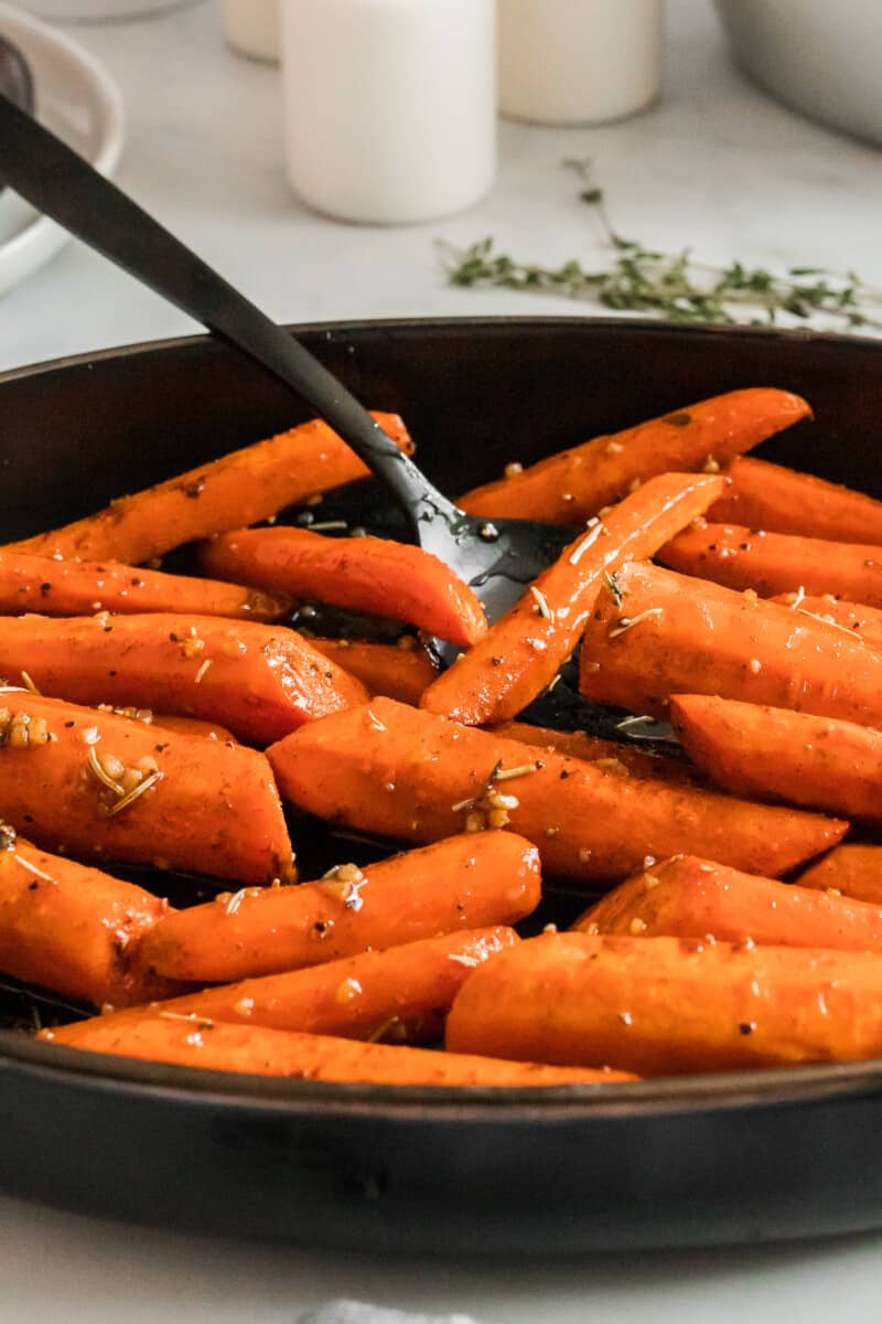 side image of brown sugar carrots with spoon