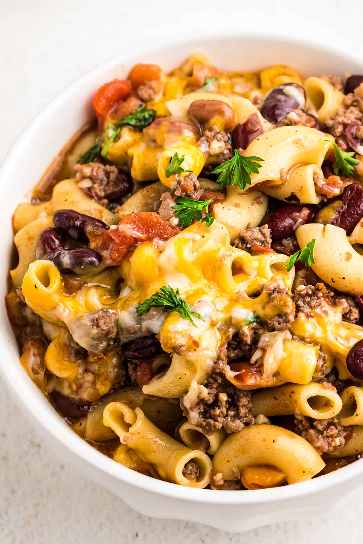 up close image of chili mac in white bowl