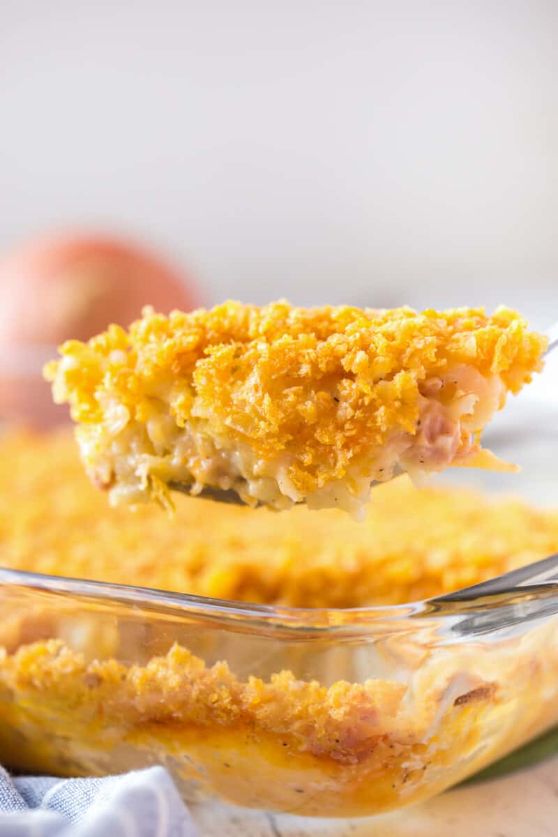 lifting up spoonful of funeral potatoes