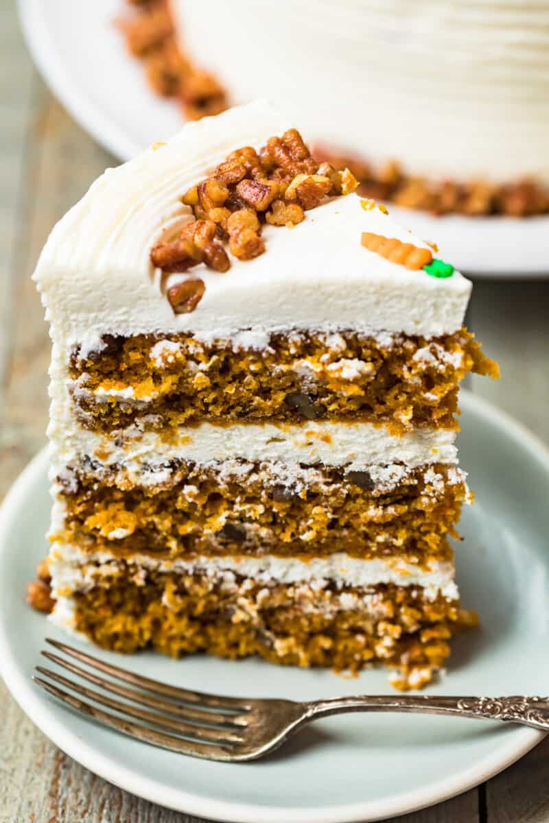 slice of carrot cake with three layers and cream cheese icing