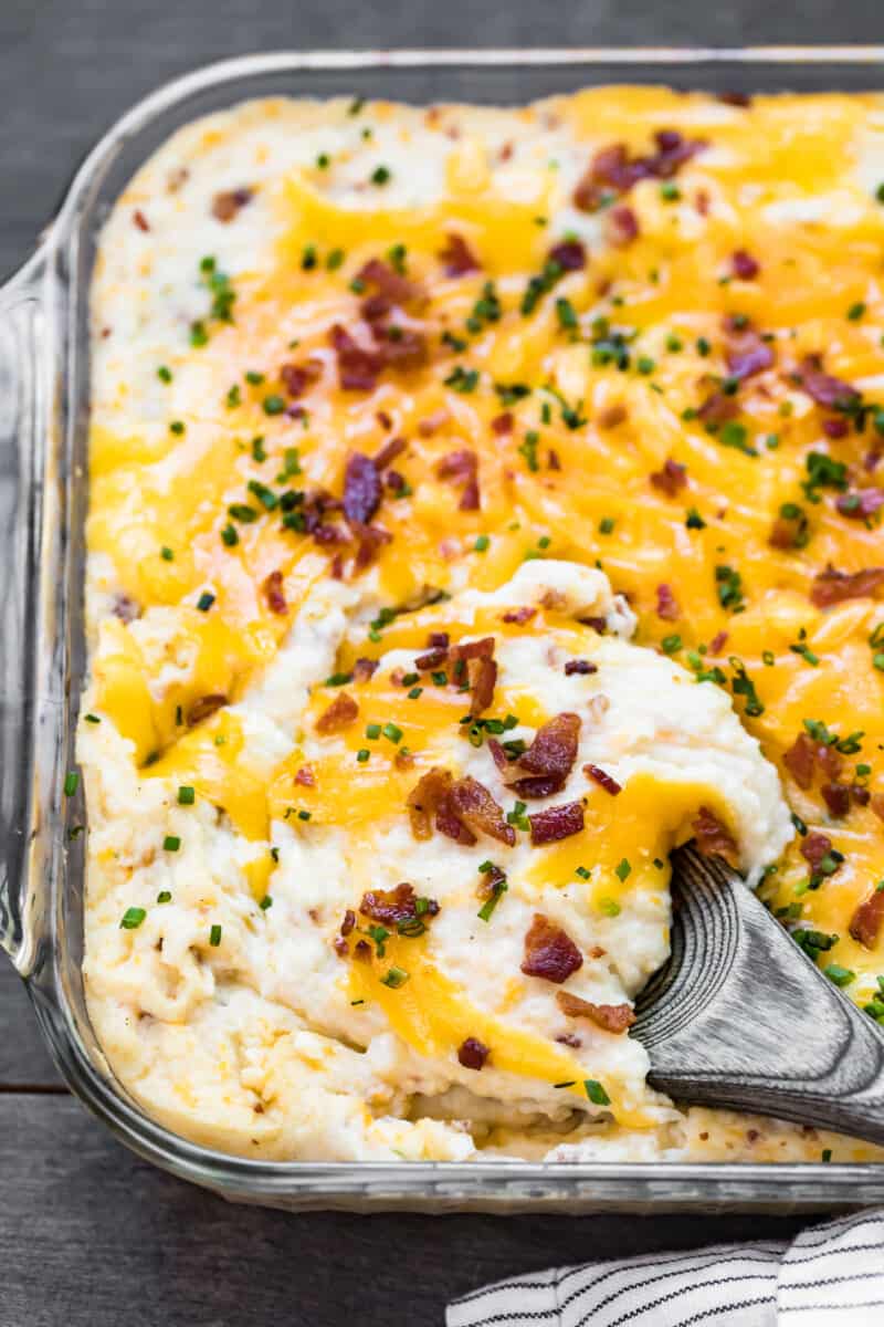 wooden spoon in loaded mashed potato casserole