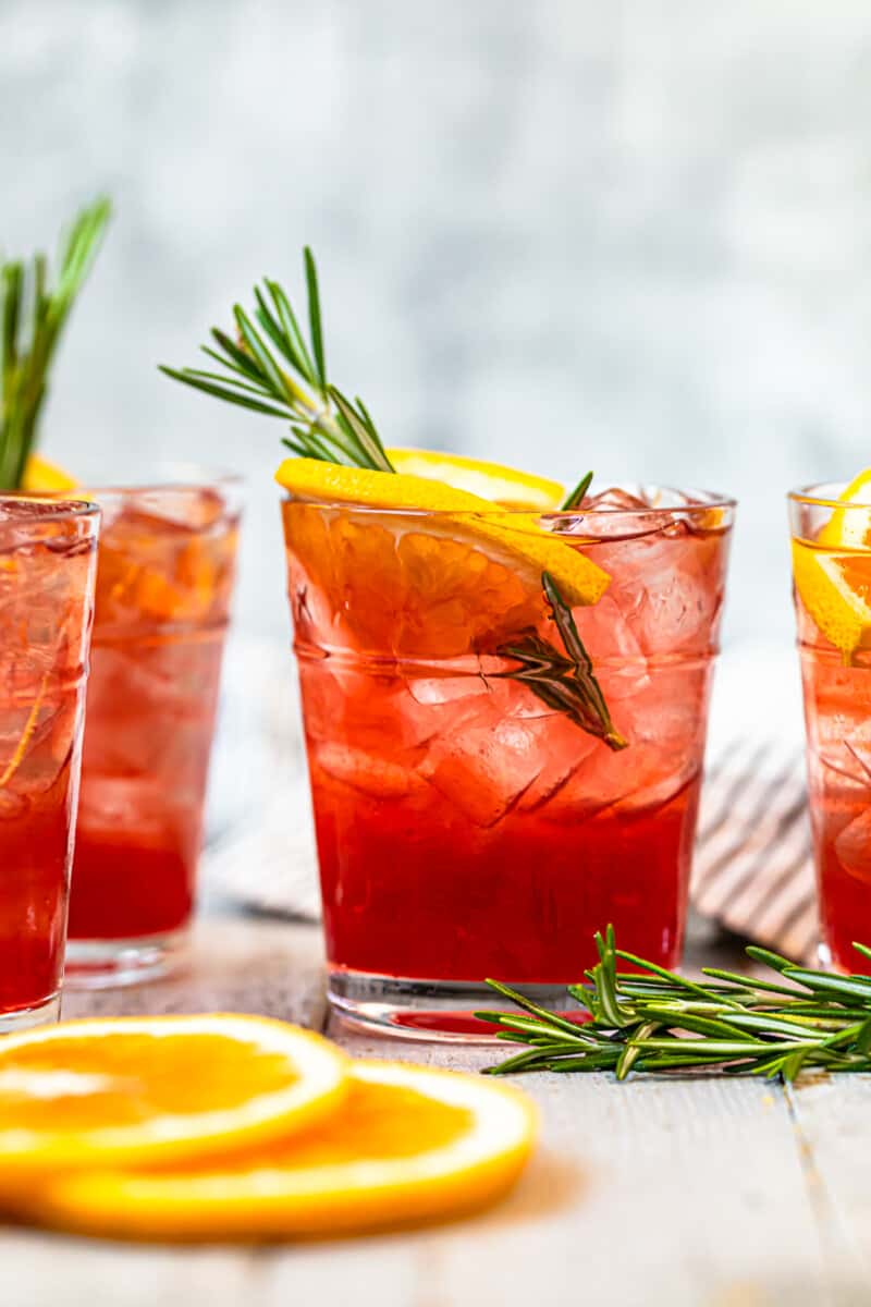 orange cranberry bourbon smash garnished with orange and rosemary