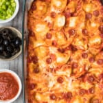 pierogy pizza casserole in baking dish next to toppings