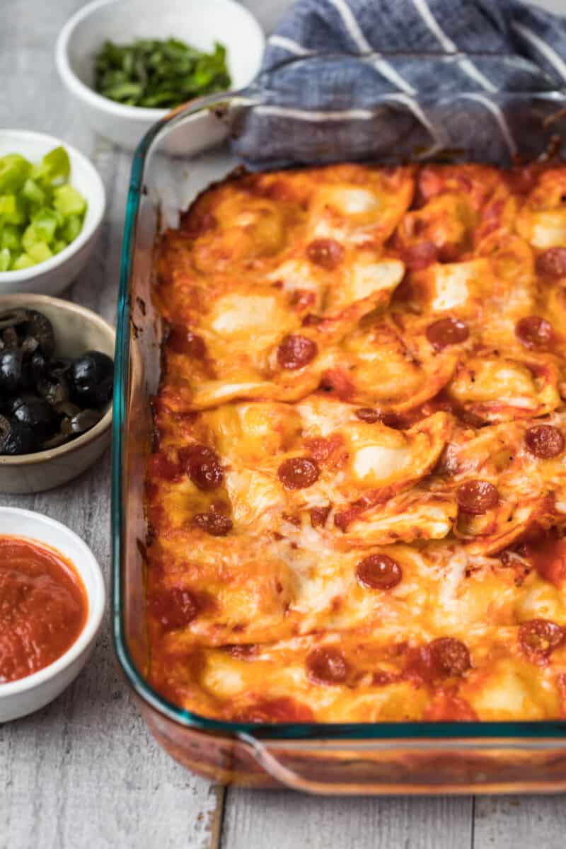 pierogy pizza casserole in baking dish next to toppings