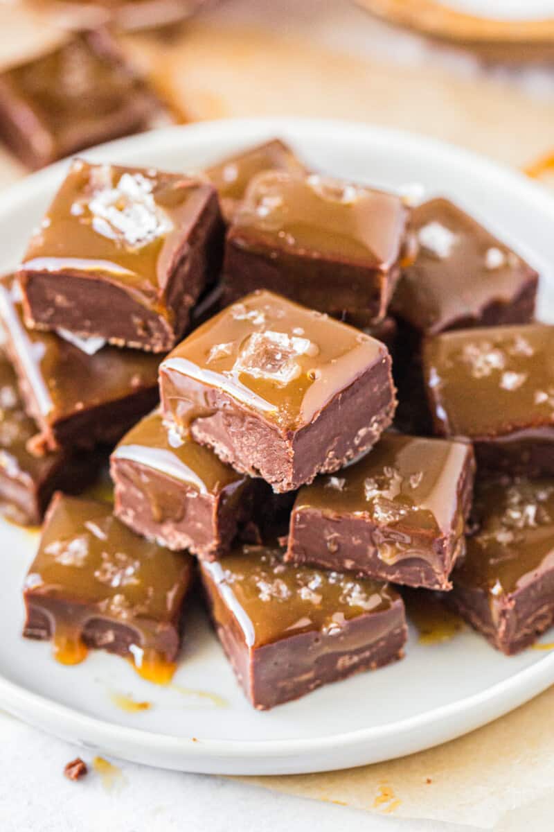 stacked salted caramel chocolate fudge on white plate