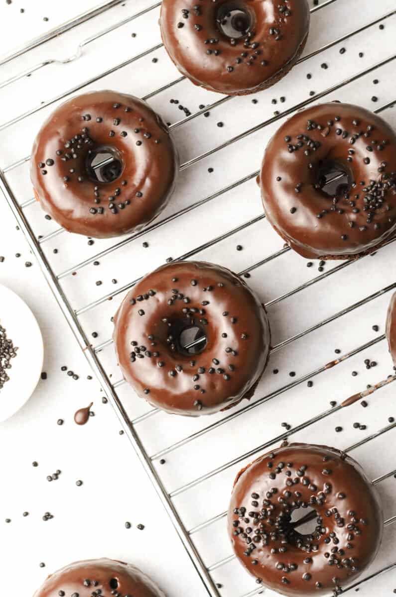 chocolate donuts on cooling rack